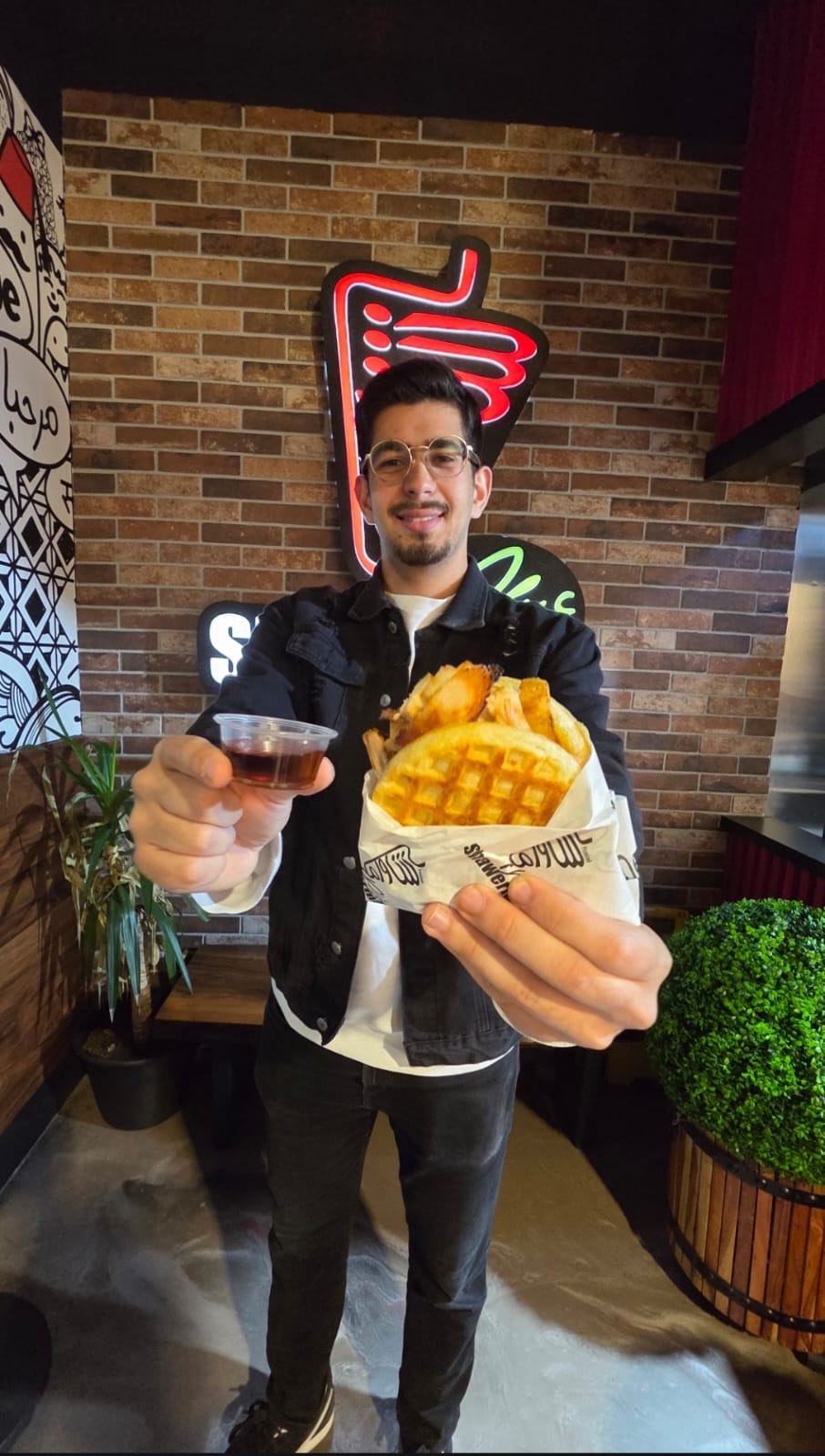 Customer holding a Shawerma Plus meal and drink